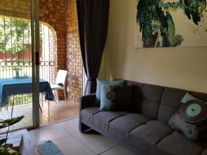 a living room with a couch and a table at Kington Guest Suite in Pretoria