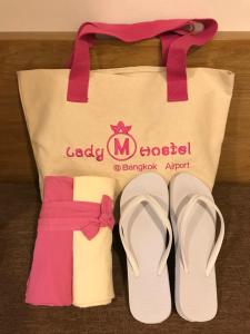 a pair of flip flops and a tote bag at Mariya Lady Hostel Suvarnabhumi Airport in Lat Krabang