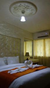 Postel nebo postele na pokoji v ubytování Setrac Orange Hotel