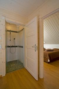 a bathroom with a shower and a bed in a room at Saimaa Lakeside in Ruokolahti