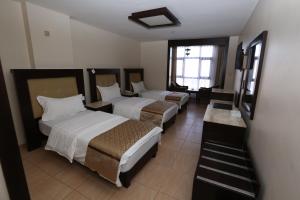 Postel nebo postele na pokoji v ubytování Al Zaitouna Hotel + 13 fotografií