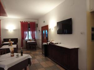 a dining room with a table and a television on the wall at San Marco in Montecchio Maggiore