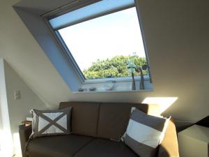 a skylight in a room with a couch and a window at Living-art in Wangerooge