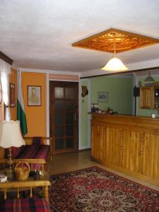 a living room with a couch and a ceiling fan at Guest House Bolyarka in Koprivshtitsa