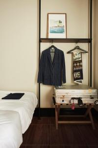 a bedroom with a bed and a dresser at Josh Hotel in Bangkok
