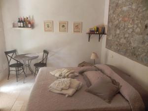 a bedroom with a bed with pillows and a table at Locanda di Terramare in Gabbro