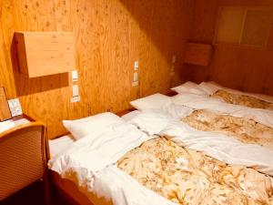 Krevet ili kreveti u jedinici u objektu Guesthouse Otaru Wanokaze