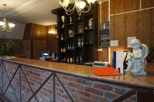 a bar with a statue on the counter at Villa Tatiana on Surikova in Kaliningrad