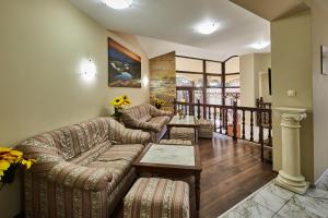 a living room with a couch and a table at Guest House Mira in Sapareva Banya