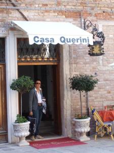 a man standing in the doorway of a casa quentin at Locanda Casa Querini in Venice