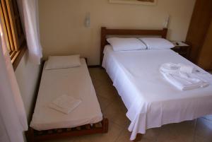Posteľ alebo postele v izbe v ubytovaní Pousada Tempo Rei