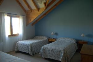 a bedroom with two beds and a window at La Estancia in Trevelin