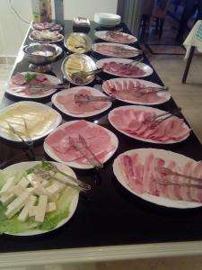 a long table with plates of food on it at Hotel Oaza in Budva