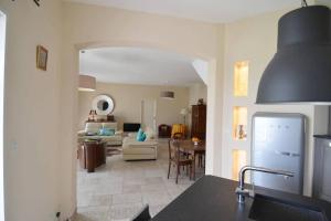 a kitchen and living room with a couch and a table at A True Paradise for unforgettable vacation – Villa Pool and Sea View in Nice