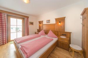 a bedroom with a large bed and a window at Glösalm in Ramsau am Dachstein +44 photos