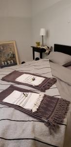 a bed with a brown and white blanket on it at The House of Taly & Erez in Neta‘im