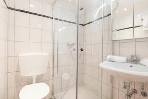 a bathroom with a shower and a toilet and a sink at Achen Appartement in Bad Hofgastein