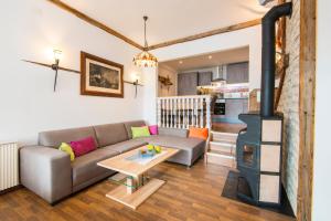 a living room with a couch and a wood stove at Achen Appartement in Bad Hofgastein