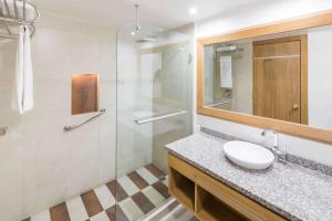 a bathroom with a sink, toilet and shower at Wyndham Garden Quito in Quito
