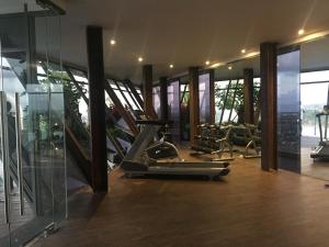 a gym with several treadmills and elliptical machines at Apartemen Uttara the Icon in Yogyakarta