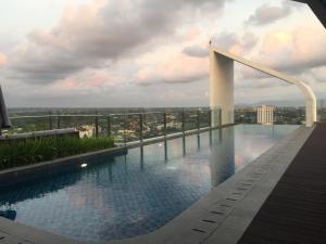 a swimming pool on the roof of a building at Apartemen Uttara the Icon in Yogyakarta