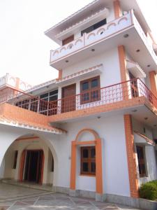 a house with balconies on the top of it at Momotaro House in Bodh Gaya