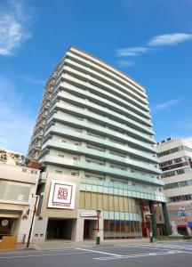 a tall building with a sign in front of it at Kobe Motomachi Tokyu REI Hotel in Kobe