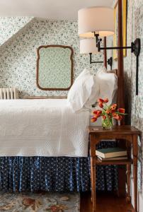 a bedroom with a bed and a table with a lamp at Sugar Hill Inn in Sugar Hill