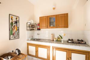 a kitchen with wooden cabinets and a sink at Villa La Casita in Cavelossim