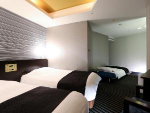 Postel nebo postele na pokoji v ubytování APA Hotel & Resort Tokyo Bay Makuhari