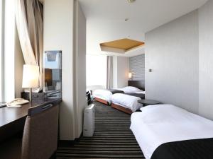 Postel nebo postele na pokoji v ubytování APA Hotel & Resort Tokyo Bay Makuhari