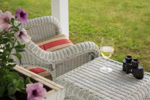 a white wicker table with a glass of white wine at Sugar Hill Inn in Sugar Hill