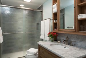 a bathroom with a sink and a glass shower at Sugar Hill Inn in Sugar Hill