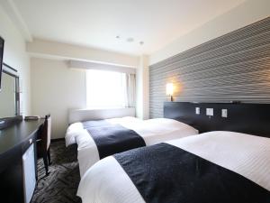 Postel nebo postele na pokoji v ubytování APA Hotel & Resort Tokyo Bay Makuhari
