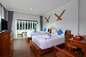 Postel nebo postele na pokoji v ubytování Princess River Kwai Hotel