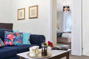 a living room with a blue couch and a coffee table at Birch Lane in Cradoc