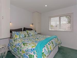 a bedroom with a bed and a window at Harbour Heights 2 in Tauranga