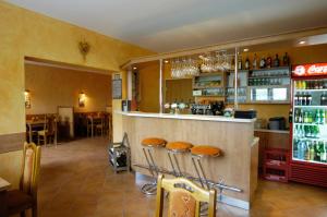 a bar in a restaurant with stools at a counter at Penzion pod Bílou Horou in Kopřivnice