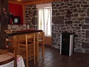 a kitchen with a stove and a stone wall at chez Angèle in Le Mont-Dore