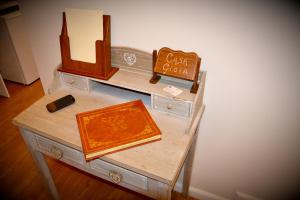 a table with a book and a sign on it at Casa Gioia in Taranto