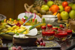 a buffet with fruit and drinks on a table at Royal Ours Blanc Boutique Hôtel & Spa in L'Alpe-d'Huez