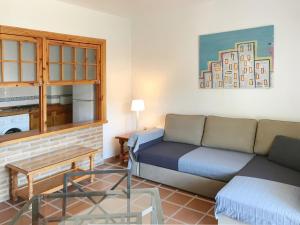 a living room with a couch and a table at APARTAMENTOS LA MUNDIAL - Alojamiento en Málaga capital in Málaga