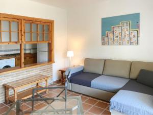 a living room with a couch and a table at Apartamentos Turísticos La Mundial in Málaga