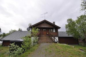 a house with a staircase leading up to a building at Beitostølen Hytter in Beitostøl