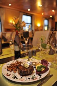 a plate of food on a table in a restaurant at Hotel Bergischer Hof in Ratingen