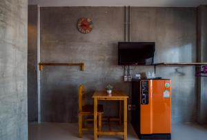 a kitchen with a small table and a refrigerator at Lovely Guesthouse 94 in Hua Hin