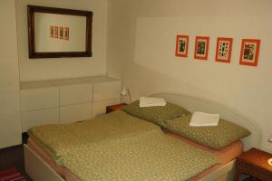 a bedroom with two twin beds and a mirror at Zelený dům in Svoboda nad Úpou +5 photos