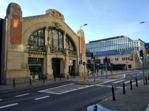 a building on a city street with a traffic light at SleepHome Poznanska in Warsaw