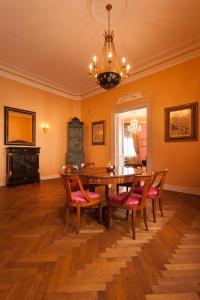 comedor con mesa, sillas y lámpara de araña en Filip’s Palace Luxurious Apartment en Liubliana