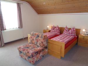 a living room with a couch and a chair at Binderhof in Weisspriach